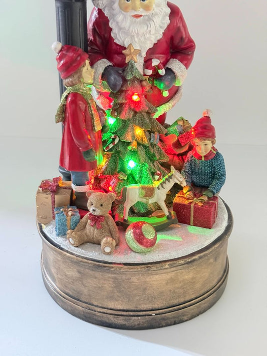 Holiday Clock with Santa, Children, and Light-Up Christmas Tree